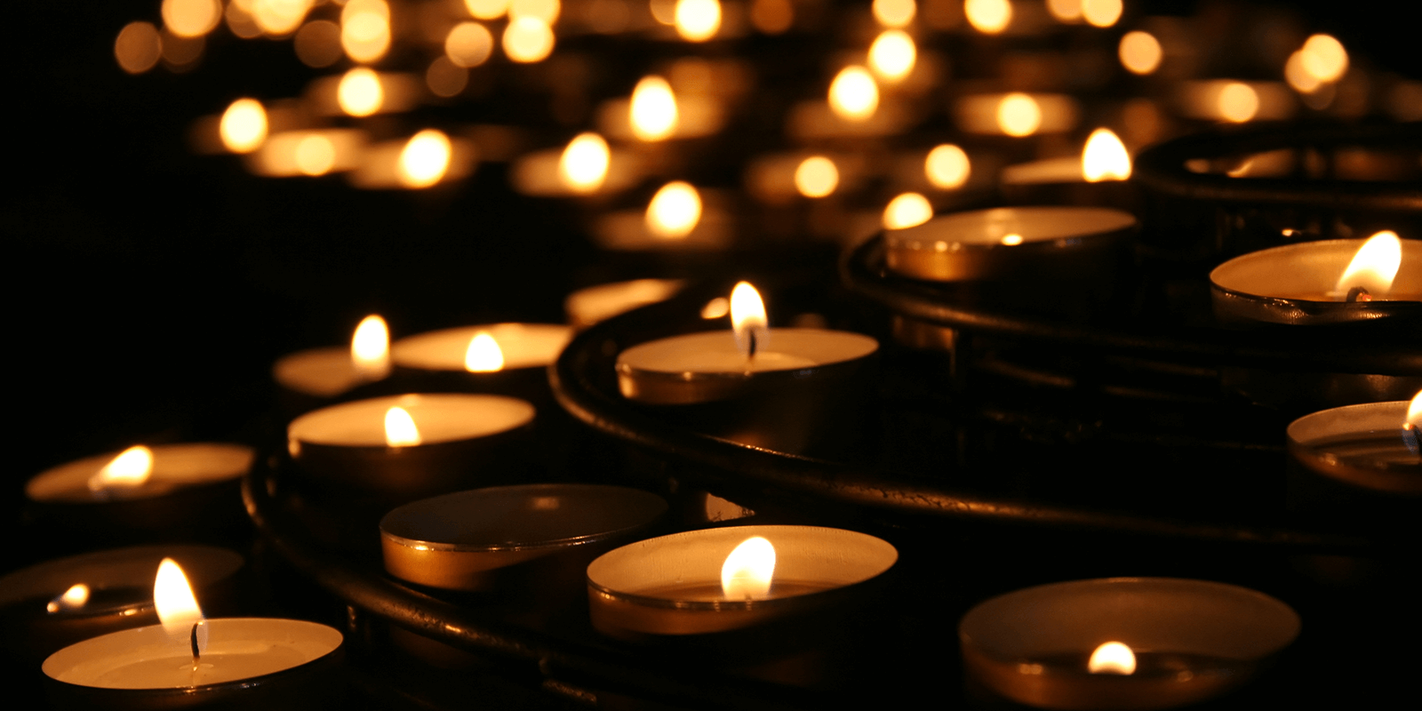 Collection lighted of votive candles for Workers Memorial Day